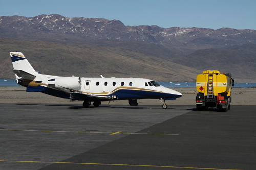 aircraft on runway with yellow fuel truck500 333